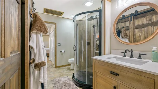a bedroom with a bed and a mirror