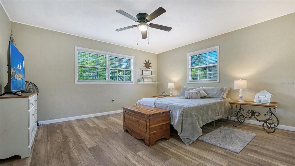 3818 Gocio Rd Extention Sarasota, FL 34235 - Photo 24 of 65 a bedroom with a bed and a chandelier