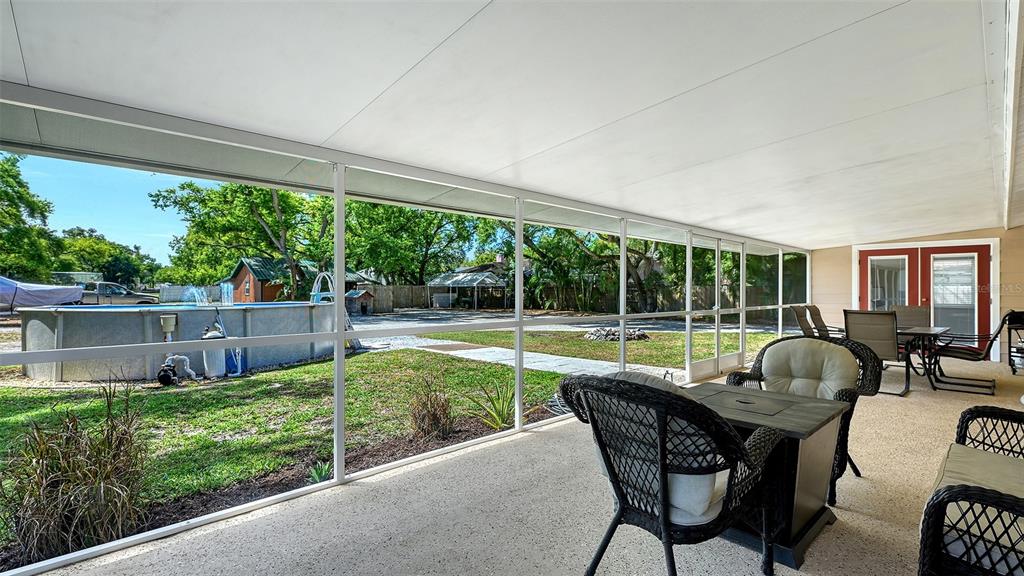 3818 Gocio Rd Extention Sarasota, FL 34235 - Photo 30 of 65 a patio with yard table and chairs