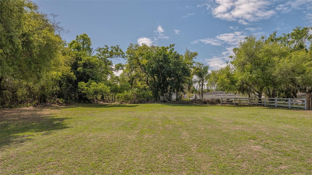 3818 Gocio Rd Extention Sarasota, FL 34235 - Photo 59 of 65 a view of a field with trees in front of it