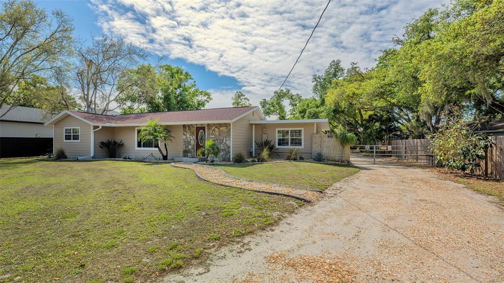 3818 Gocio Rd Extention Sarasota, FL 34235 - Photo 60 of 65 a front view of a house with a yard and garage