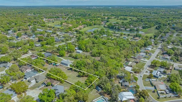 an aerial view of a houses with a yard