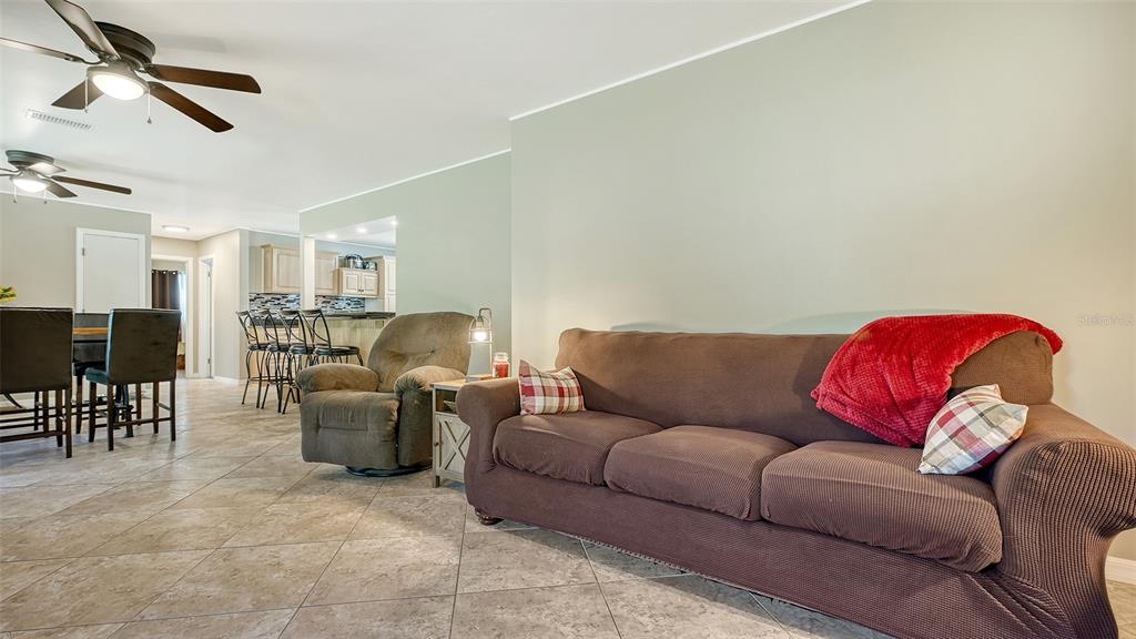 3818 Gocio Rd Extention Sarasota, FL 34235 - Photo 9 of 65 a living room with furniture a ceiling fan and a rug