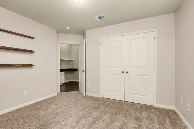 a view of an empty room with a fireplace
