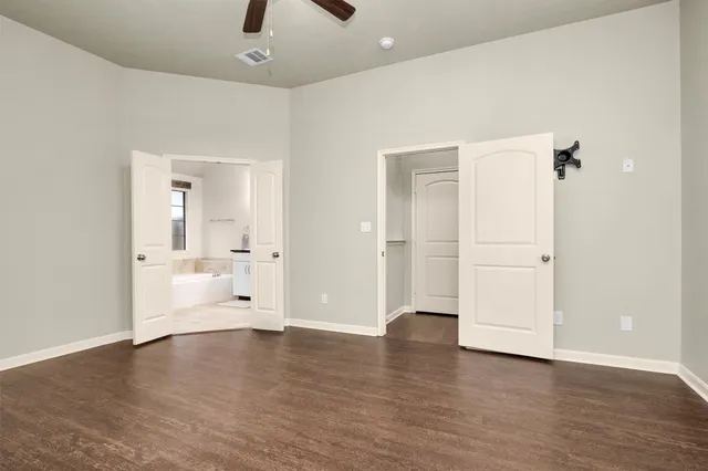 a bathroom with a granite countertop sink a mirror a bathtub and shower