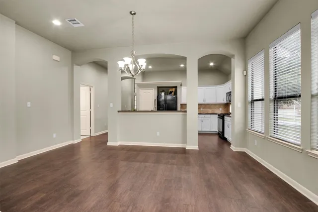 a view of a kitchen with a dishwasher cabinets and a large window
