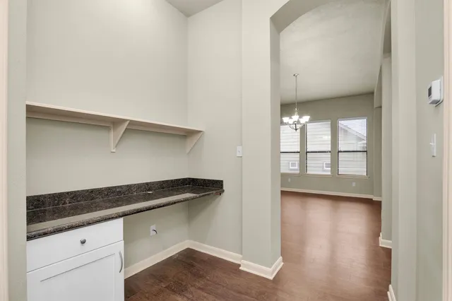 a kitchen with granite countertop a sink and a stove