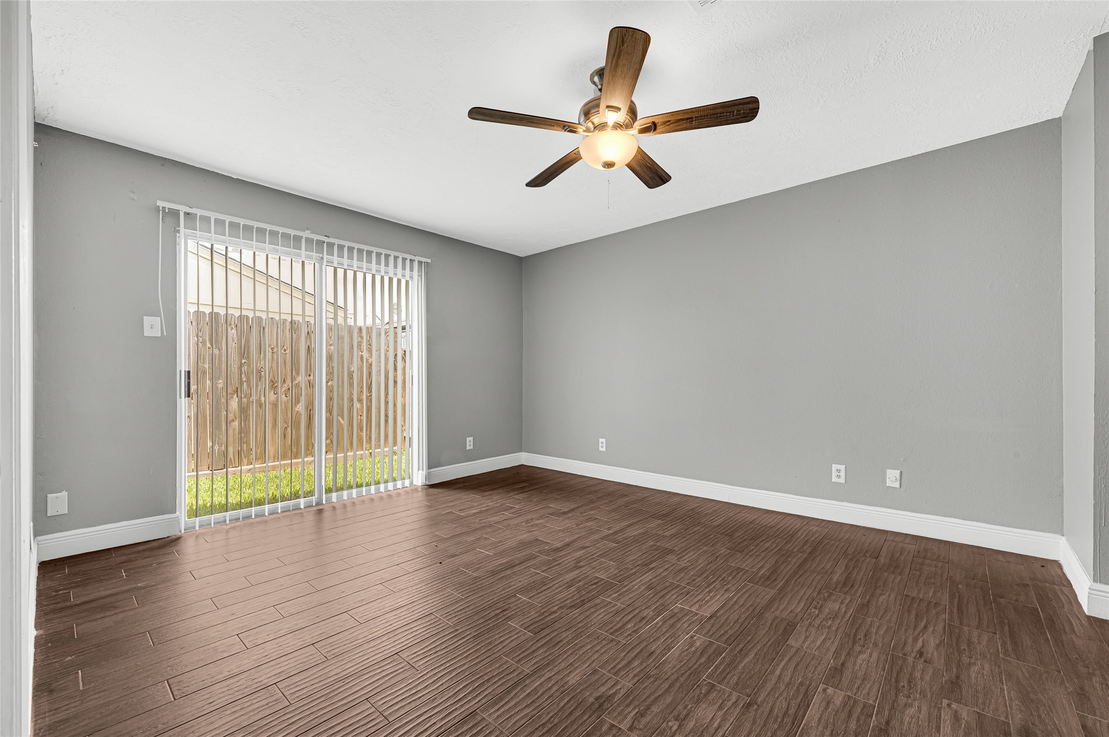 4170 Amir Street Houston, TX 77072 - Photo 14 of 18 a view of an empty room with wooden floor and a window