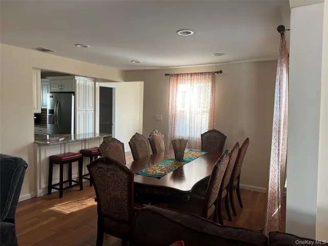 a view of a dining room with furniture and window