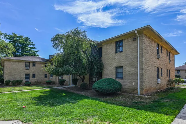 a view of a patio with a table chairs under an umbrella