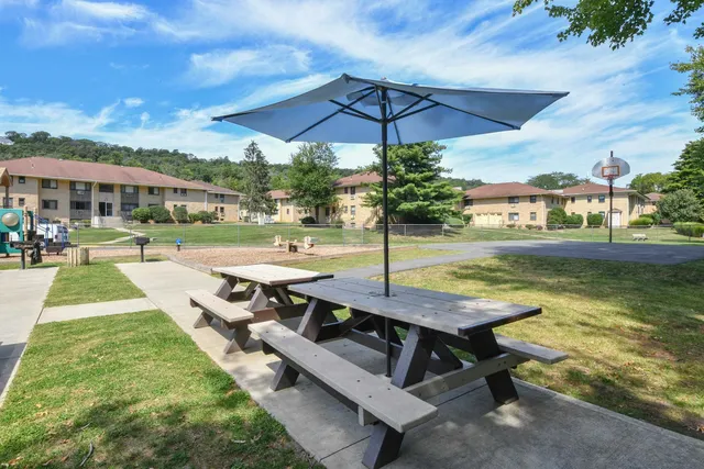 a view of a dining room with a table and chairs
