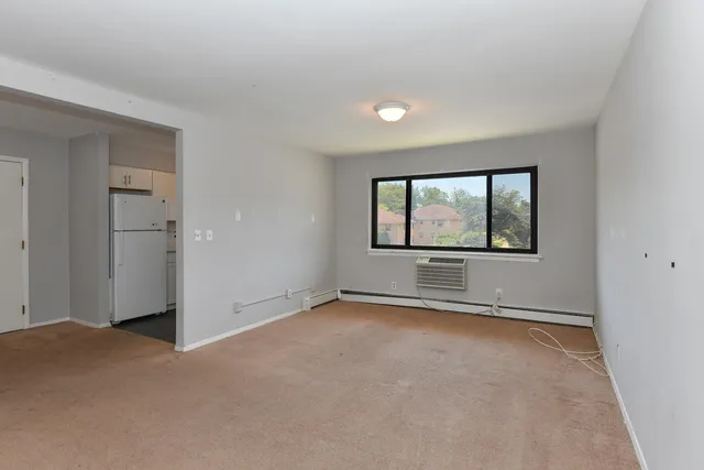 an empty room with a empty space and windows