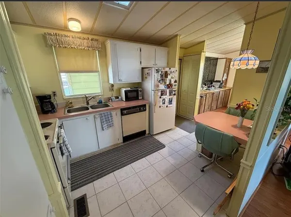 a kitchen with a sink appliances and cabinets