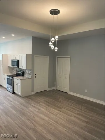 a view of a kitchen with stainless steel appliances a refrigerator and microwave