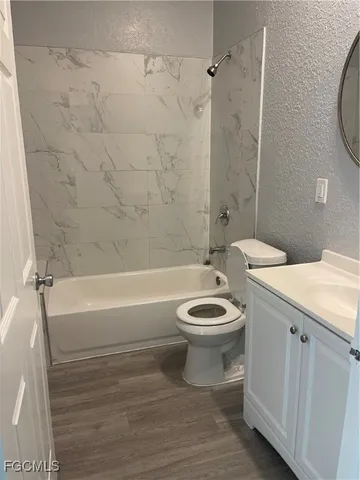 a bathroom with a toilet a sink and bathtub