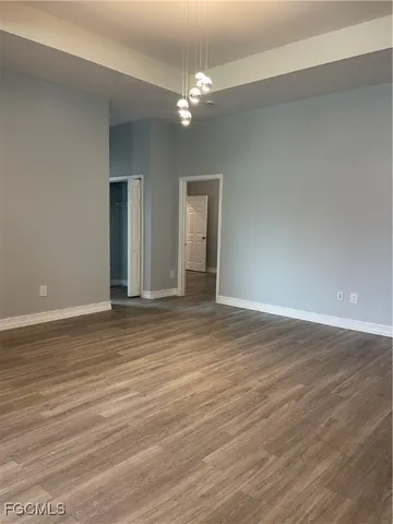 a view of a room with wooden floor