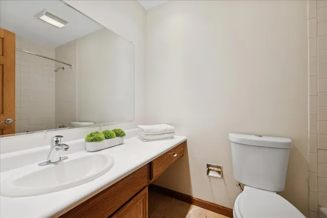 a bathroom with a sink toilet and a mirror