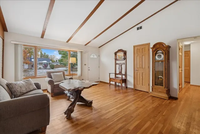 a living room with furniture window and wooden floor