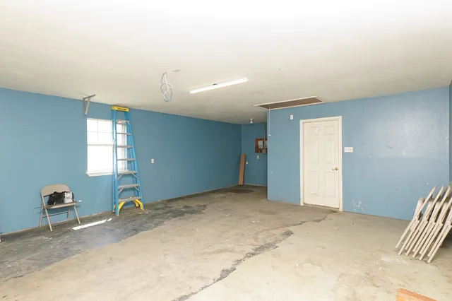 a view of a room with wooden floor and window