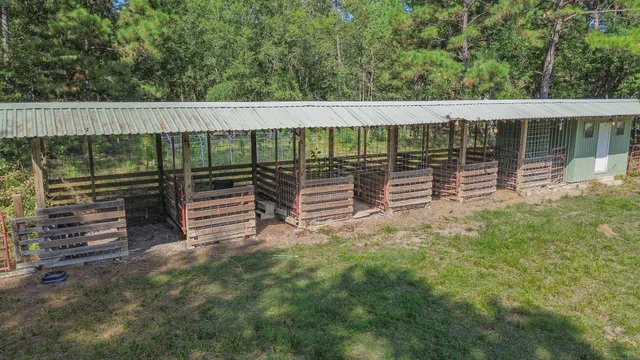 a backyard of a house with barbeque oven and wooden fence