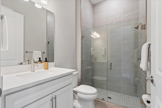 a bathroom with a sink toilet and shower