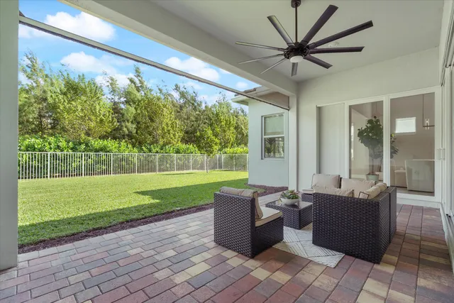 a living room with couch and a garden view