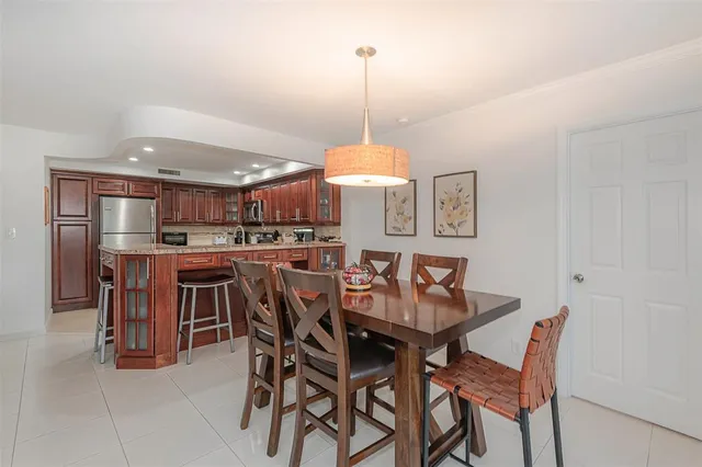 a dining room with furniture a chandelier and window