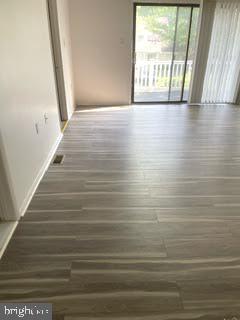 9129 Tulip Grove Road Gaithersburg, MD 20879 - Photo 12 of 23 a view of an empty room with wooden floor and a window