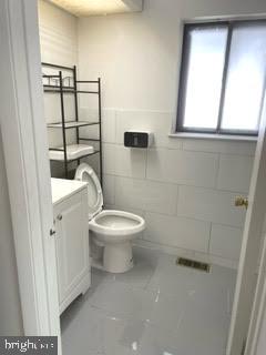 9129 Tulip Grove Road Gaithersburg, MD 20879 - Photo 14 of 23 a white toilet sitting next to a bathroom sink