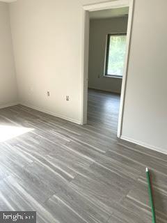 9129 Tulip Grove Road Gaithersburg, MD 20879 - Photo 19 of 23 a view of an empty room with wooden floor and a window