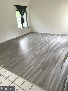 9129 Tulip Grove Road Gaithersburg, MD 20879 - Photo 3 of 23 a view of a room with wooden floor and window