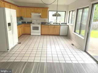9129 Tulip Grove Road Gaithersburg, MD 20879 - Photo 4 of 23 a kitchen with stainless steel appliances a refrigerator sink and microwave