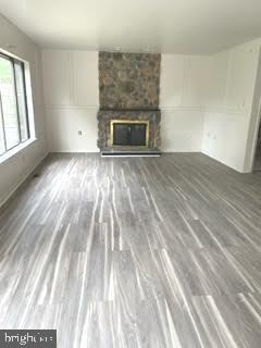9129 Tulip Grove Road Gaithersburg, MD 20879 - Photo 5 of 23 a view of empty room with wooden floor and fireplace