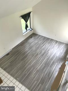 9129 Tulip Grove Road Gaithersburg, MD 20879 - Photo 6 of 23 a view of an empty room with wooden floor and a window
