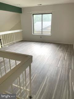 9129 Tulip Grove Road Gaithersburg, MD 20879 - Photo 9 of 23 a view of an empty room with wooden floor and window