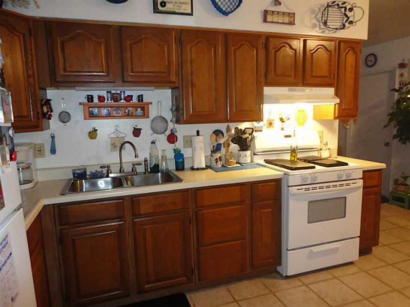 175 Bryson Road Butler, PA 16001 - Photo 4 of 13 Kitchen. OAK CABINETRY, A GAS STOVE, STAINLESS STEEL SINK AND CERAMIC TILE ADD UPDATES TO THE KITCHEN.