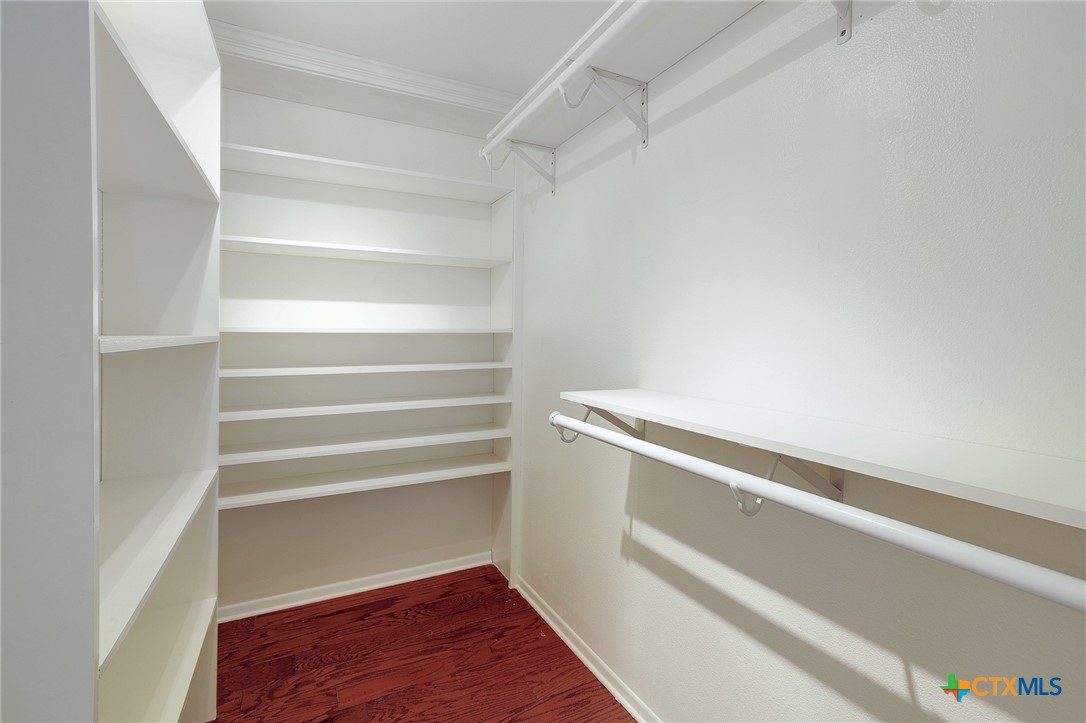 4607 Cedar Point Drive Austin, TX 78723 - Photo 13 of 27 a view of walk in closet with empty racks