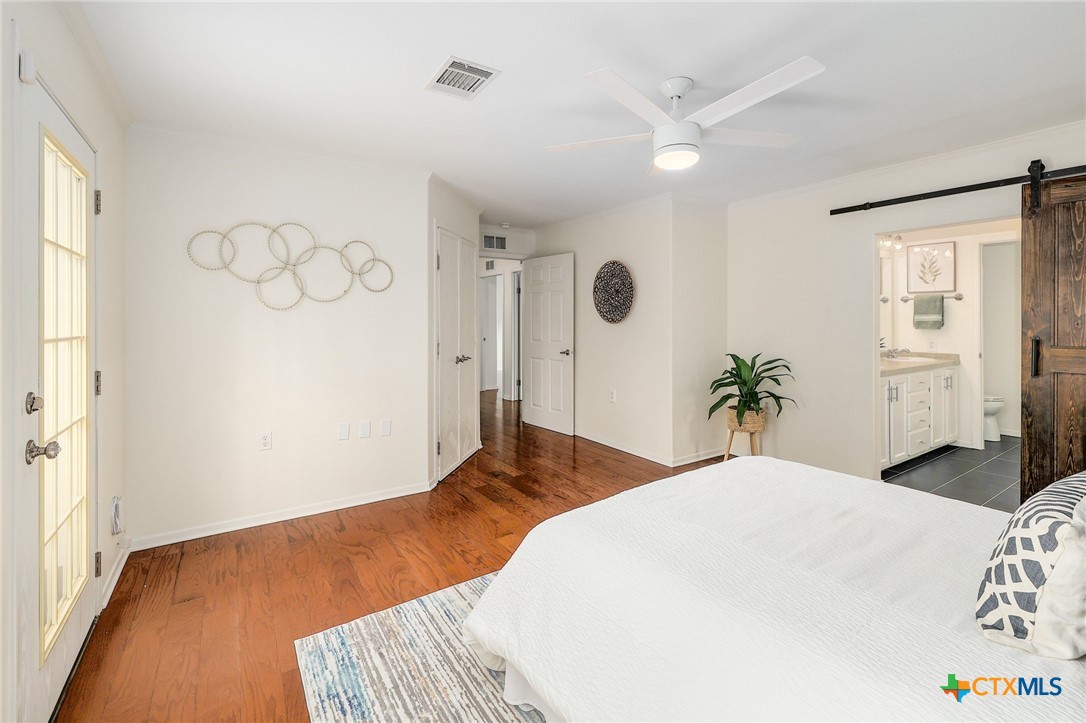 4607 Cedar Point Drive Austin, TX 78723 - Photo 10 of 27 a bedroom with a bed and a window