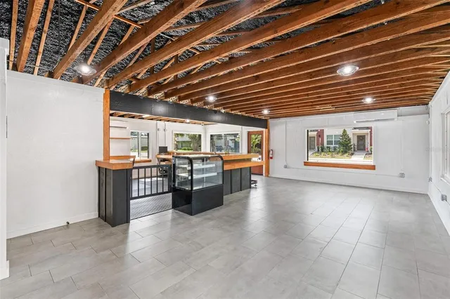 a large white kitchen with a large window