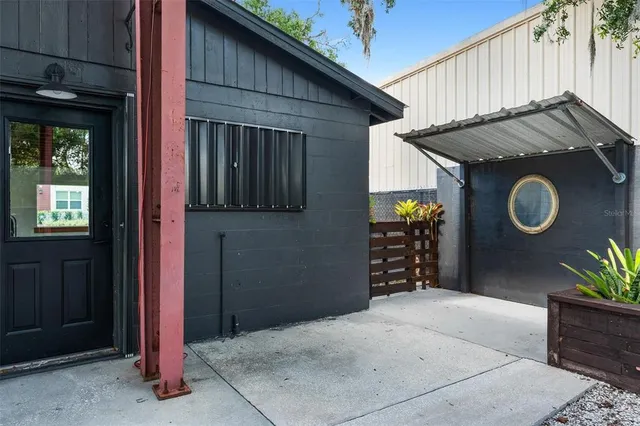 a view of patio with table and chairs and potted plants