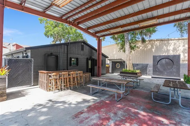 a view of a patio with table and chairs and potted plants