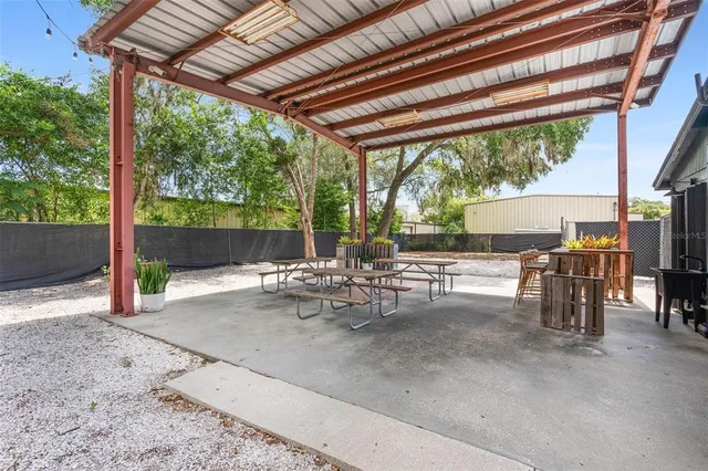 a view of a house with backyard and sitting area