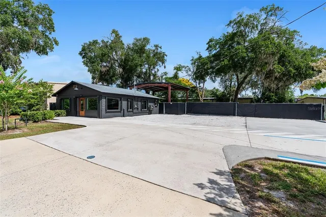 a view of house with a yard and sitting area