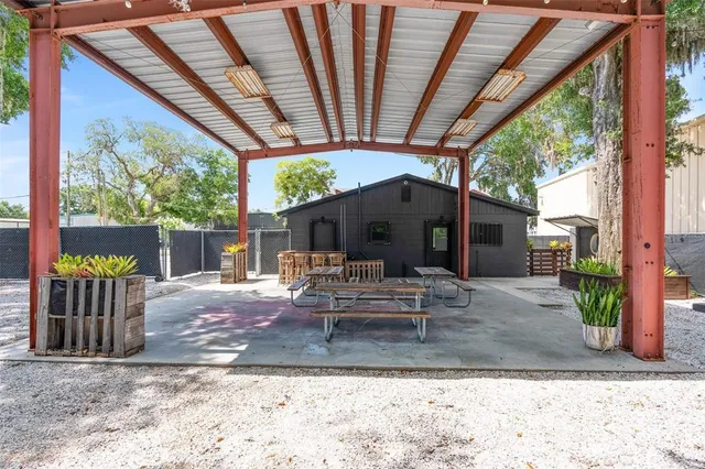 a view of a chair and tables in the patio