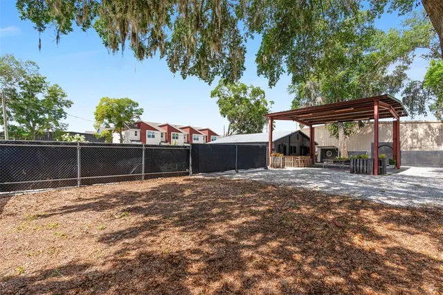 a view of a small barn in the middle of a yard