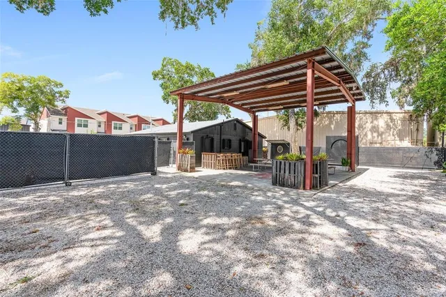 a black house with a yard and plants
