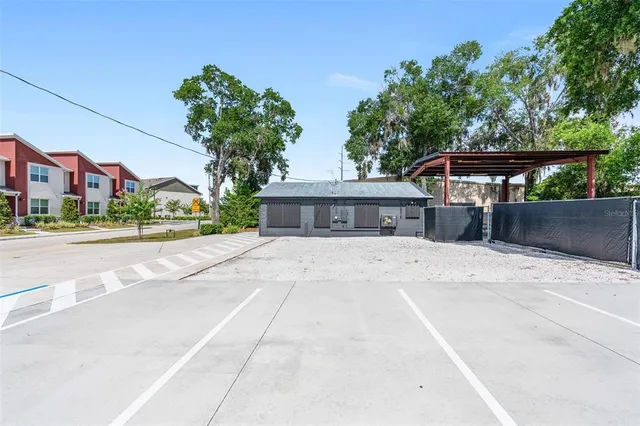 a front view of house with a yard and large trees