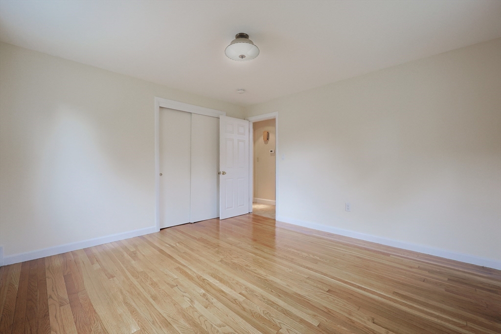 8 Greenwood Road Ashland, MA 01721 - Photo 17 of 29 a view of an empty room with wooden floor