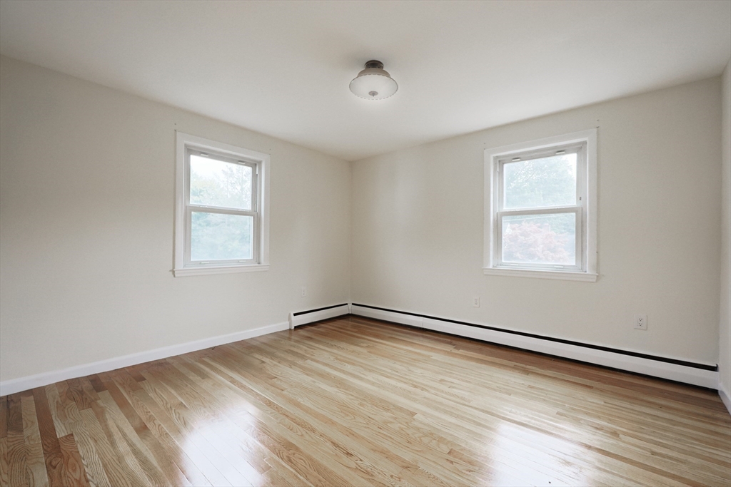 8 Greenwood Road Ashland, MA 01721 - Photo 18 of 29 a view of an empty room with wooden floor and a window
