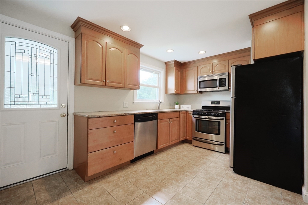 8 Greenwood Road Ashland, MA 01721 - Photo 9 of 29 a kitchen with a refrigerator stove and sink